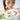 Woman admiring a pink and white birthday flower bouquet for birthday bouquet delivery in Singapore.