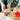 Hands placing a wrapped gift beside a Christmas hamper with biscuits and wine, illustrating a corporate gift delivery checklist.
