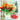 Red and yellow tulips in a glass vase beside a ribbon-wrapped box, illustrating a gift for grand opening celebrations.